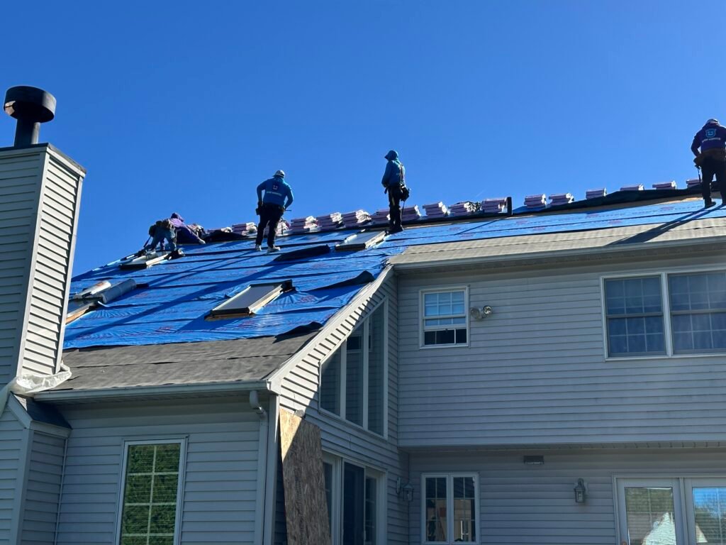 Men on a roof with Roof monster logod roofing Barrier.