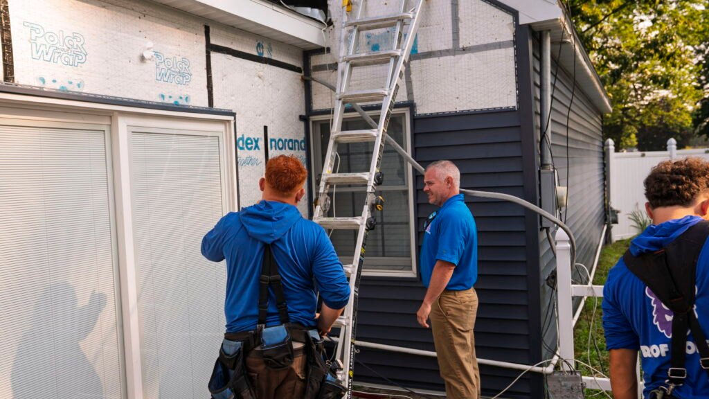 Project Manager Reviewing the Siding Installation